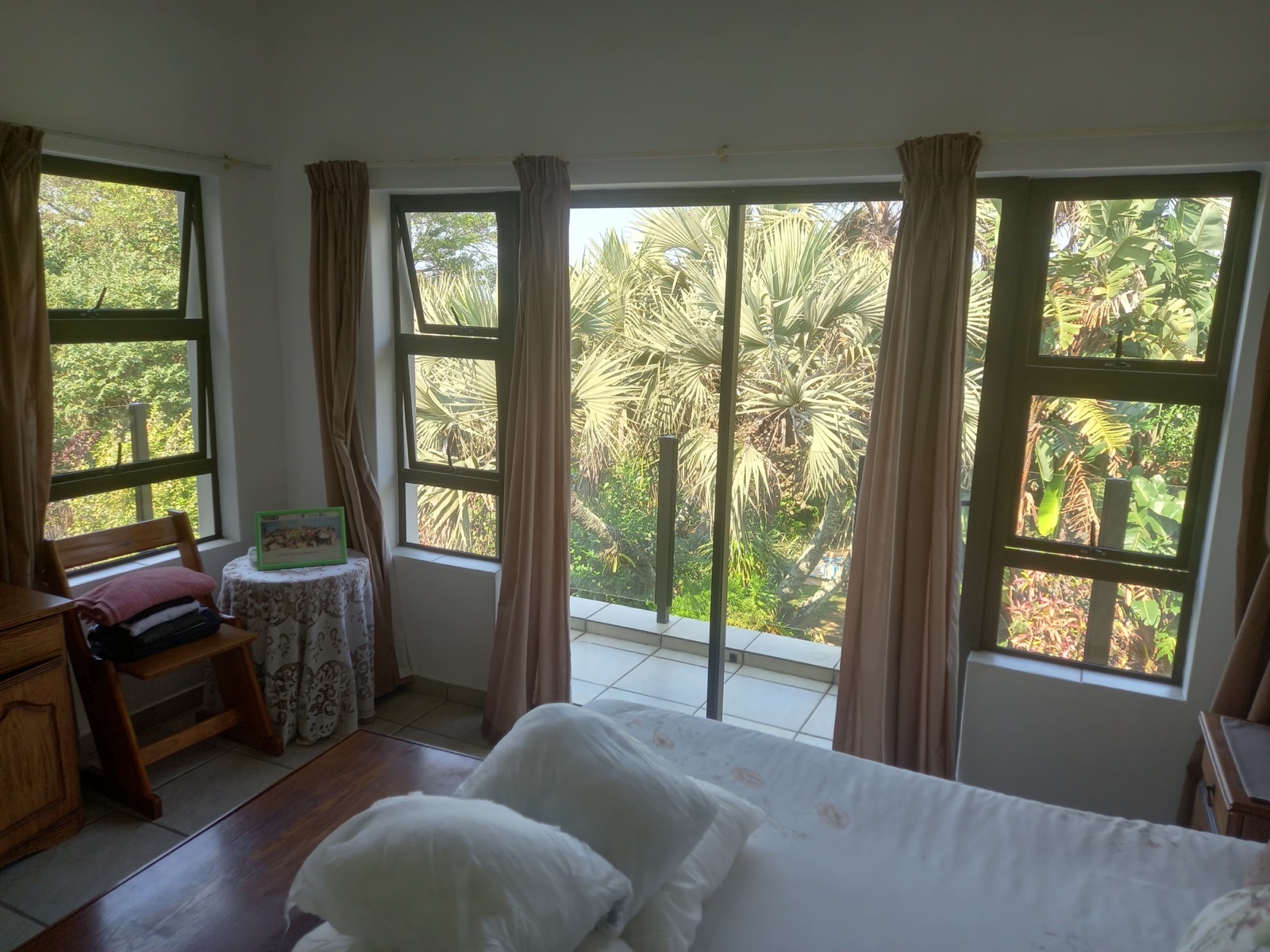 Looking out from the main bedroom to the balcony and the palms
