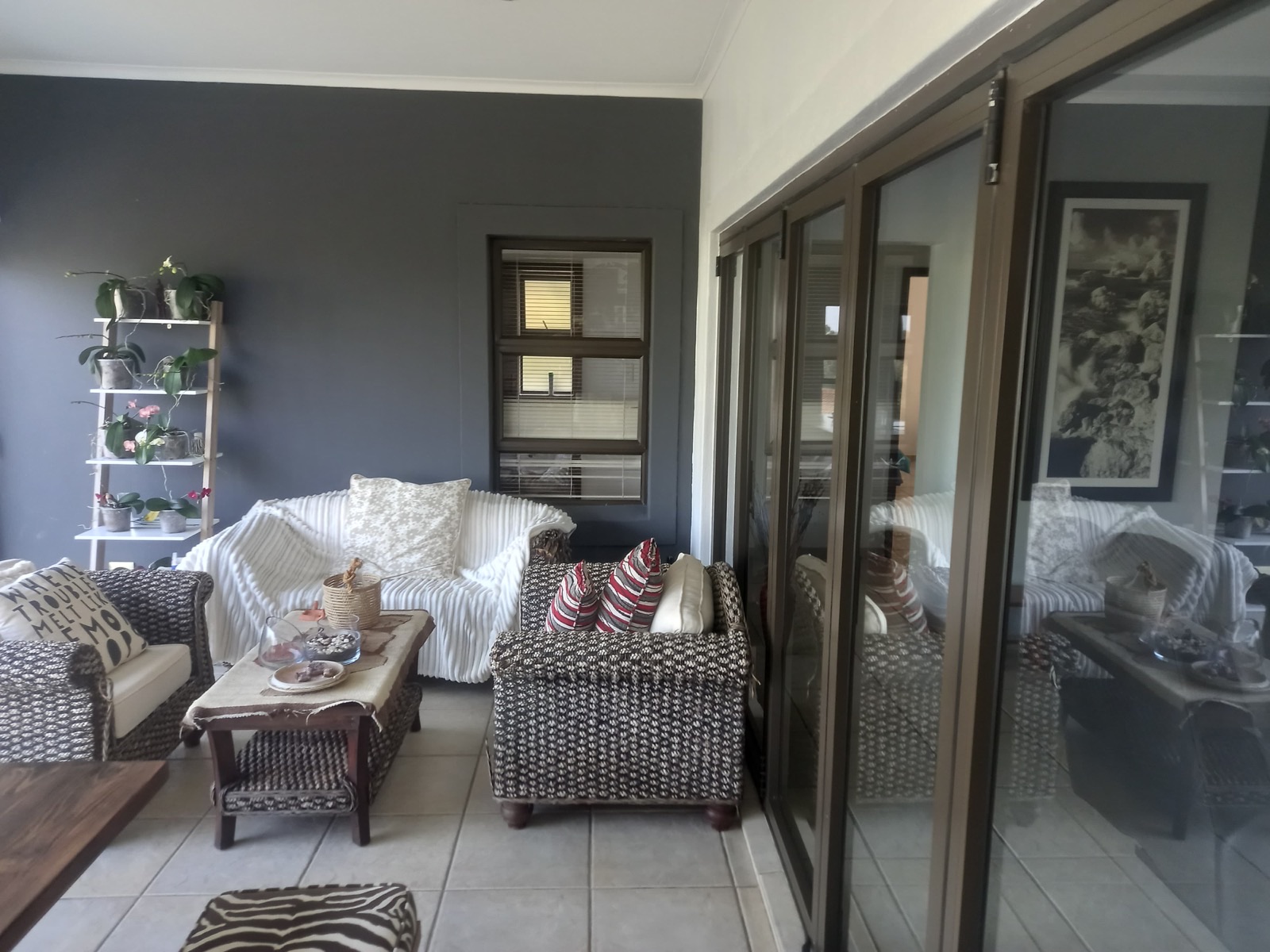 Separate sitting room with wicker armchairs